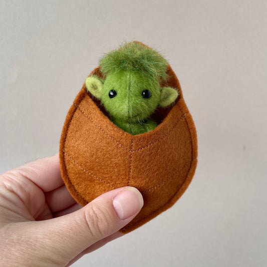 Green baby goblin with leaf pouch
